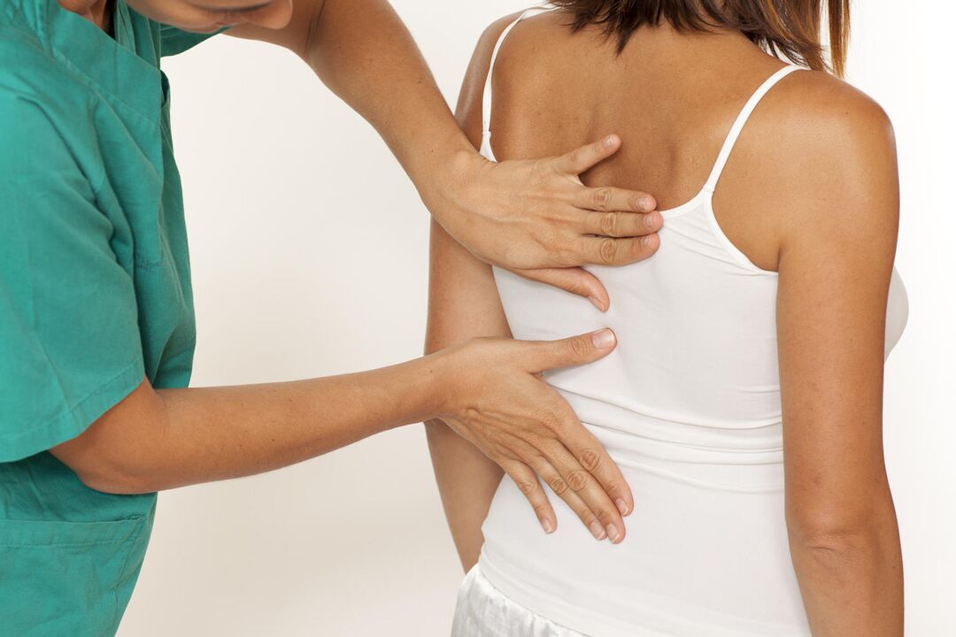 The doctor examines the back for pain in the shoulder blades.